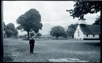 Father Patrick Logan, SS.CC., with Saint Ann Church in the distance, Heeia, Oahu.